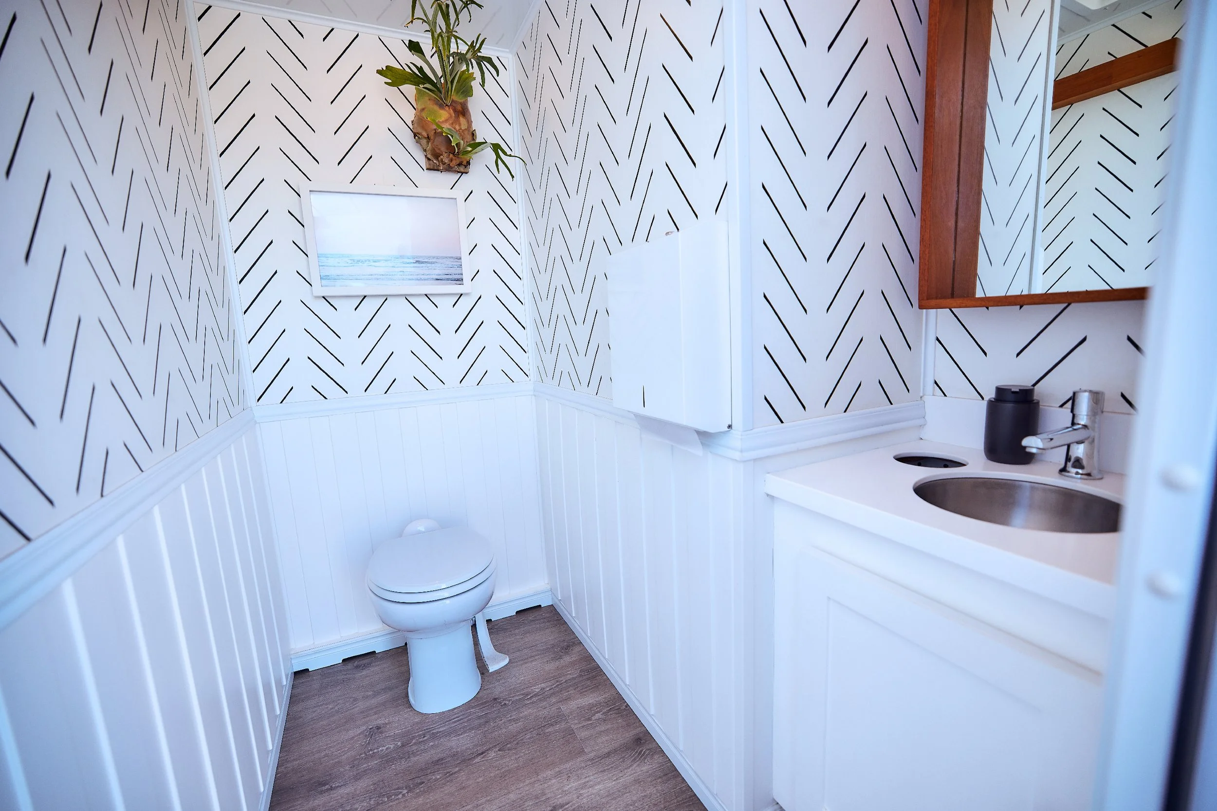 Coastal Modern women's restroom wide view